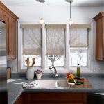 Полупрозрачные шторы рулонного типа на окне кухни