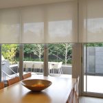 Солнцезащитные рулонные шторы на большом окне кухни-гостиной